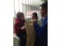 Edwin giving a child in need items that will help her while having her much needed surgery.