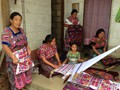 Mayan Indian Family hard at work doing their native embroidery to sell to obtain food for their families.
