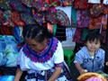 A young Mayan Child with his Grandma at the City Market of Guatemala City, Guatemala