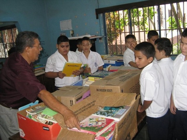 Students happy with their donation of books from the Mission of Love via the Denton Airlift.