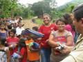 Julio is making so many children happy by giving them a donated book. Look at the happiness that a " simple " book brings to this community in Honduras.
