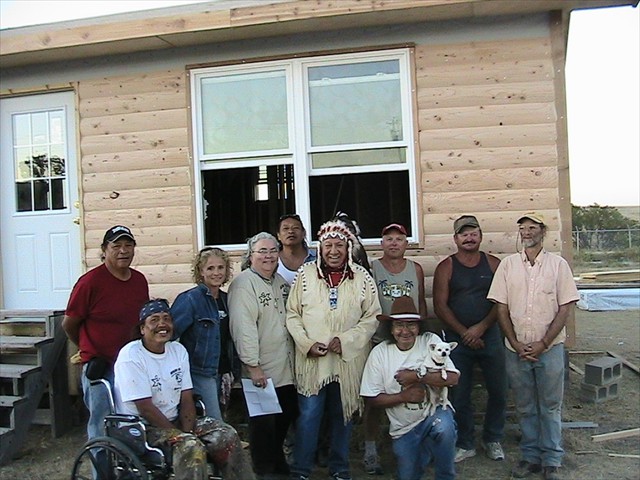 Albert Red Bear, Ben Red Bear, Kevin Poor Bear, Joe American Horse, Hobart Spotted Bear, Rusty Puckett all from Pine Ridge Native American Indian Reservation sharing their photo with Mission of LOVE building volunteers after completion of Joe American Horse Lakota Home.