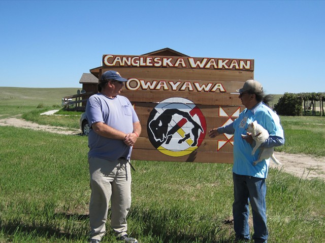 Placing a sign at the Lakota Circle Village are Hobart Spotted Bear and Donnie Shocky. Both Donnie and Hobart received a Sacred Lakota Home from our Mission of LOVE building team.