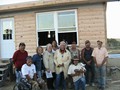 Albert Red Bear, Ben Red Bear, Kevin Poor Bear, Joe American Horse, Hobart Spotted Bear, Rusty Puckett all from Pine Ridge Native American Indian Reservation sharing their photo with Mission of LOVE building volunteers after completion of Joe American Horse Lakota Home.