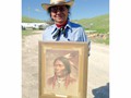 Hobart Spotted Bear holding a gift for the new homeowners to hang on their wall. We built Hobart and his wife Rose a home in Wounded Knee, S.D.