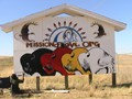 Lakota artist Kevin Poor Bear painting our Mission of LOVE Lakota logo in Kyle, S.D. Kevin started this artwork with only one pencil, is afraid of heights, and has no legs and only gets around in a wheel chair to sell his artwork to feed his family. This was completed in two days.